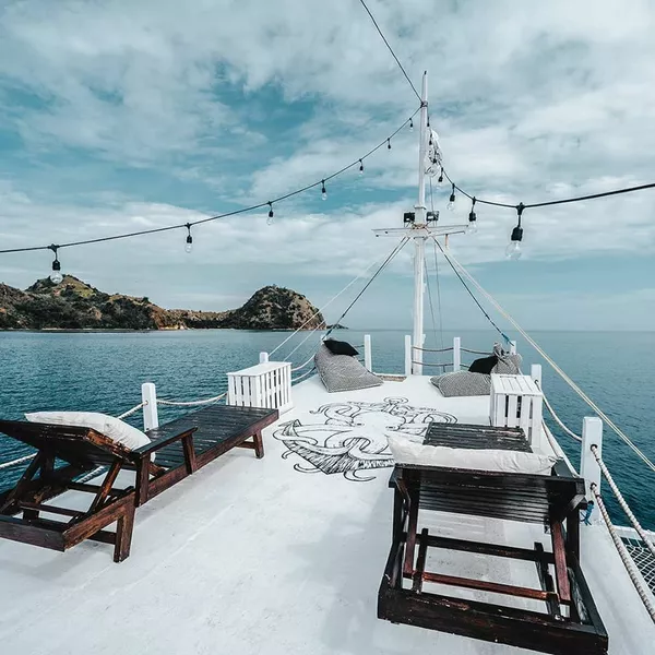 La Famille private Komodo liveaboard deck with sun daybeds and sea view during a 4D3N cruise from Labuan Bajo