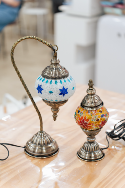 Mini Arabic-style mosaic lanterns with blue and orange geometric tile patterns on a table in a Singapore art studio