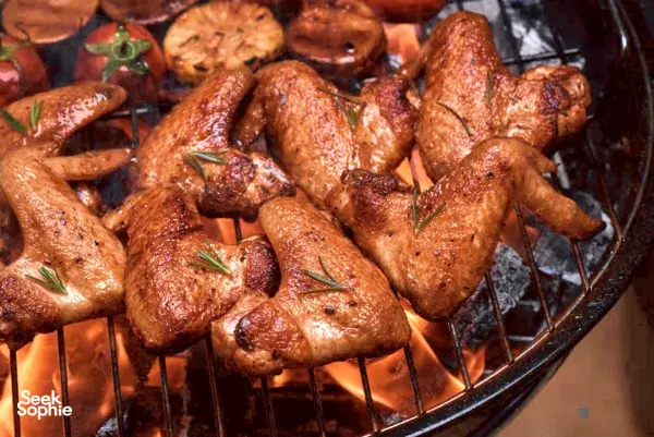 Roasting skewers of chicken on the grill aboard the Mawali Sailing yacht during a Kota Kinabalu sunset sail