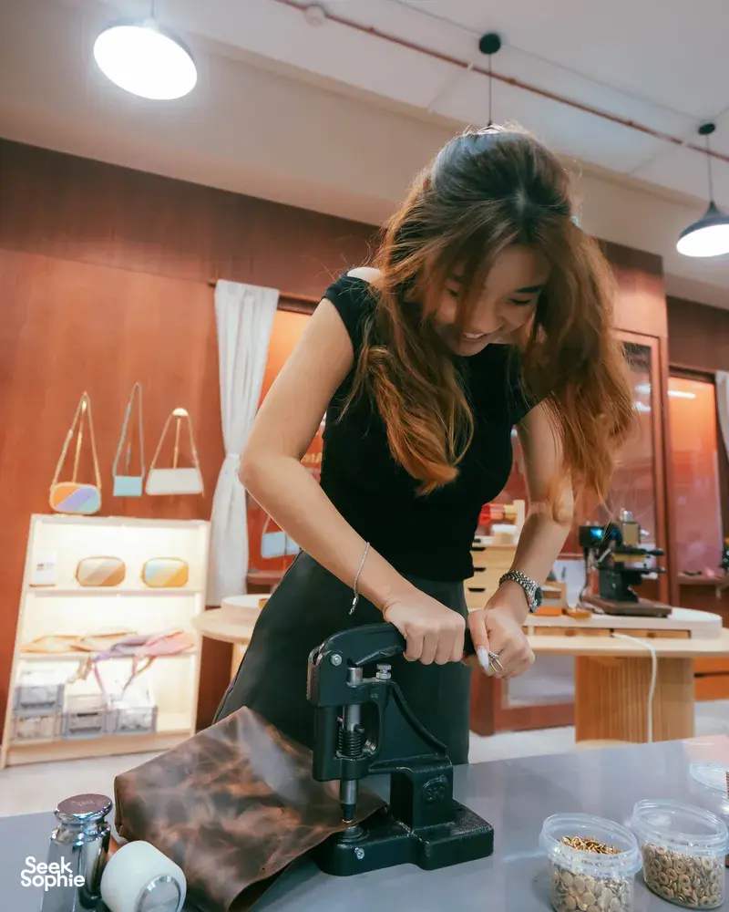 Maker stitching a leather bag at Crafune in New Bahru, Singapore during leather bag workshops in Singapore