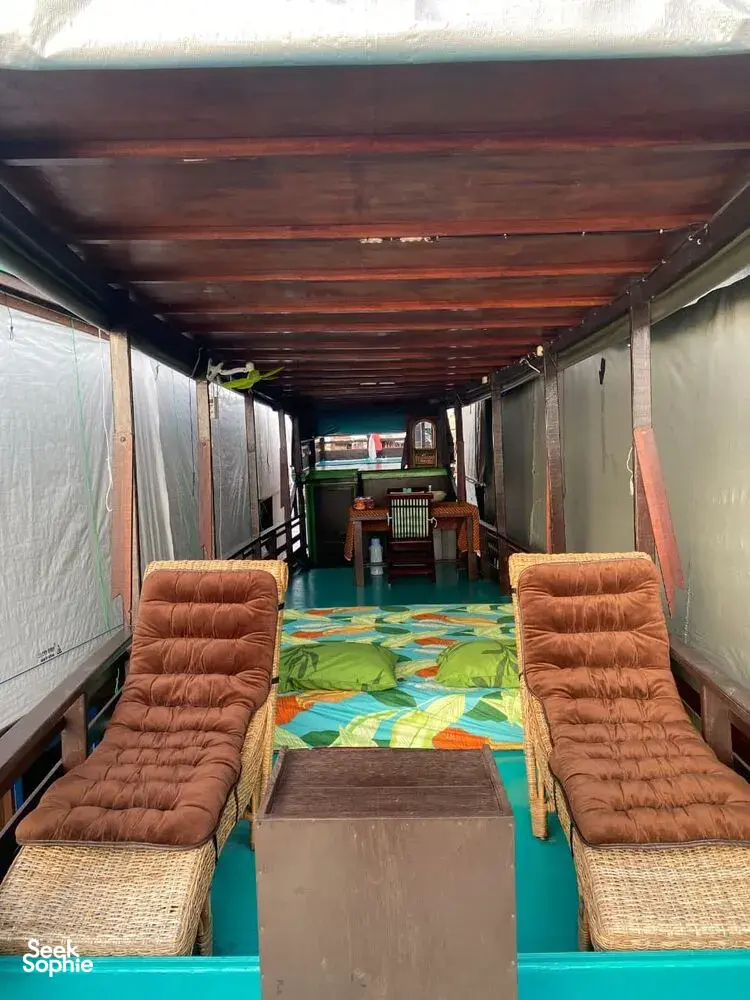 Cozy cabin on a small boat for a 3D2N Tanjung Puting cruise in Pangkalan Bun, with two lounge seats inside
