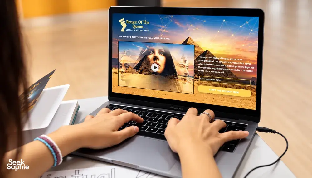 Hands typing on a laptop showing the 'Return of the Queen' virtual escape quest for FunEmpire—team bonding activities Singapore