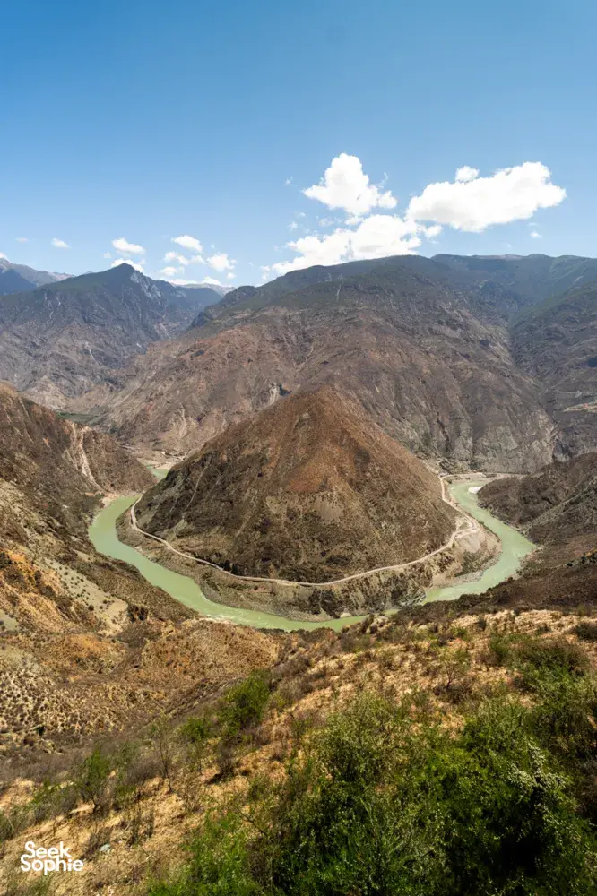 Winding turquoise river curving through rugged valleys in Meili country during a 2D2N sunrise adventure from Shangri-La