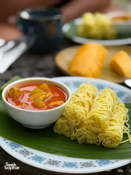 Malaysian comfort food of noodles and curry soup served on a banana leaf at Kebun Lidstari farmhouse kitchen in Langkawi