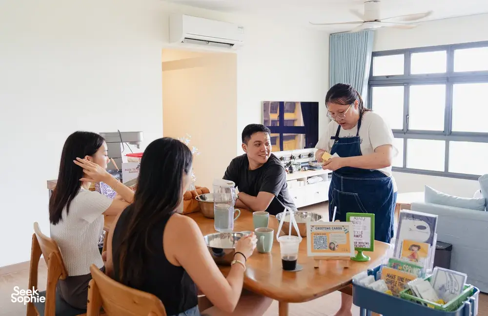 Baking class in a bright kitchen: participants prepare ingredients and drinks while the host demonstrates shio pan—workshops in Singapore