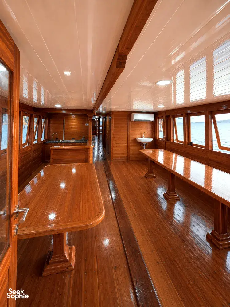 Wooden phinisi bathroom with bathtub and washbasin beside windows for a 3D2N shared Komodo cruise onboard, Komodo Island