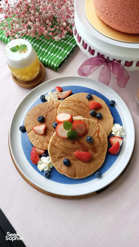 TCM-inspired teatime pancakes with berries on a blue platter at a Singapore workshop, hands-on workshops in Singapore