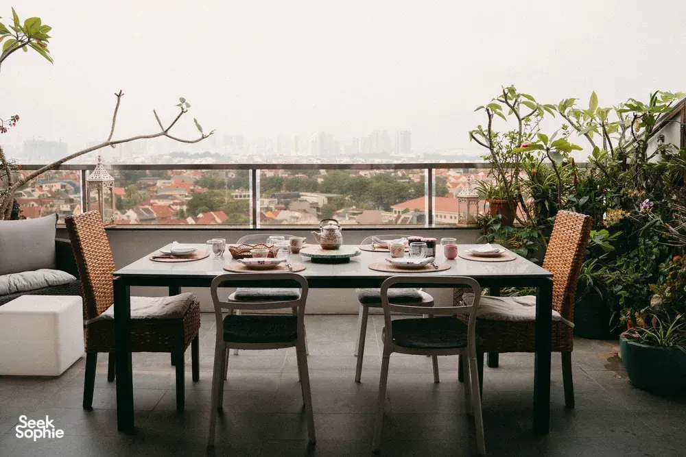 Laid dining table on a Singapore balcony for a French Cooking Lab croissant baking experience with city views