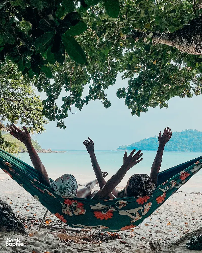 Hammock on the sandy beach of Surin Island, with the Andaman Sea beyond, relaxing under leafy trees near Khao Lak