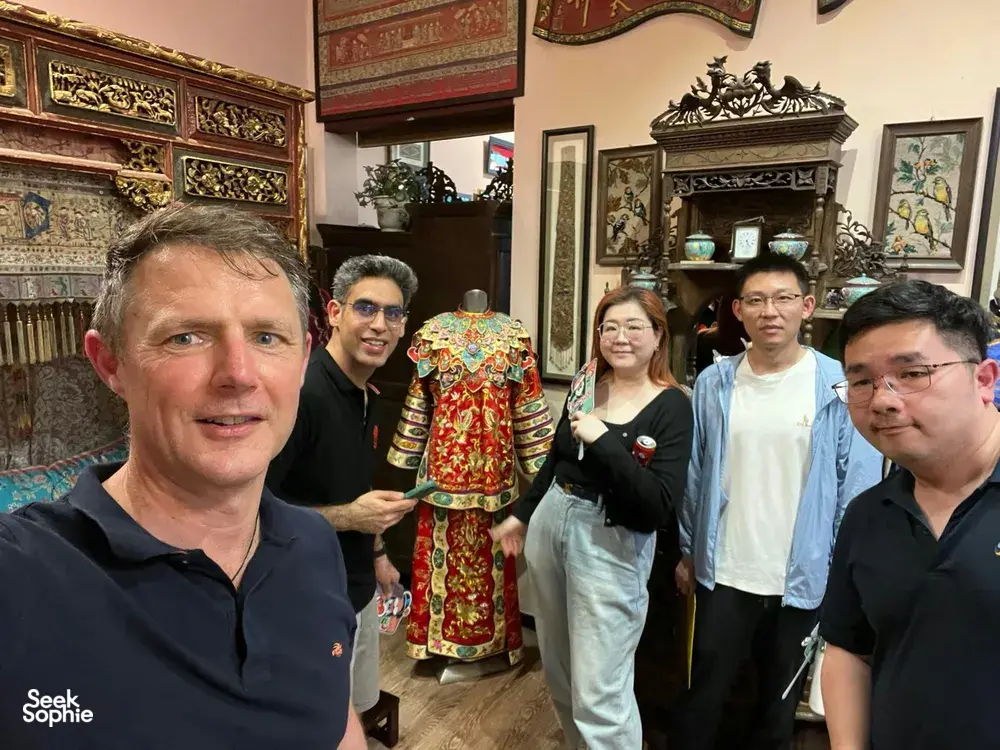 Group viewing traditional decor in a shop during a real-life Monopoly team experience in Katong-Joo Chiat, Singapore hidden gems