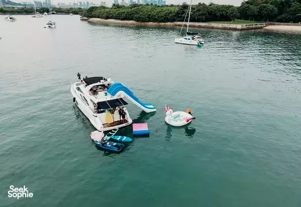 Zen Sea yacht moored in Singapore harbour with kayaks, SUP boards and inflatable water toys ready for Lazarus Island