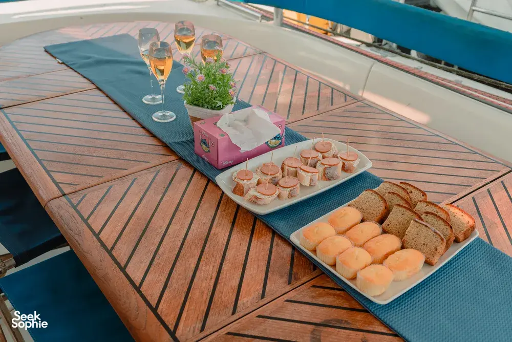 Breakfast spread on the deck of a catamaran sailing off Kota Kinabalu, with pastries, muffins and fresh drinks