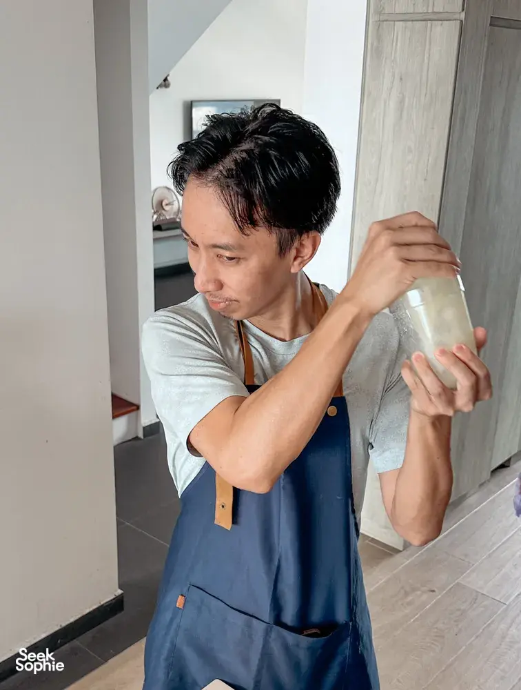 The TCM Chef in Singapore pours and tastes a drink while preparing TCM herbal mocktails for a food-as-medicine class