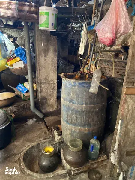 Hanoi Red River village workshop with metal drums, pipes and containers for low-waste traditional food making