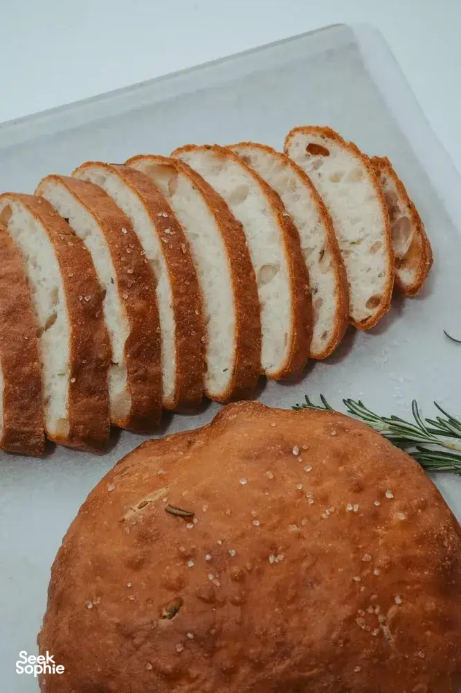 Focaccia loaves sliced on a tray with herb specks and a round loaf, served at a Singapore bread workshop — workshops in Singapore