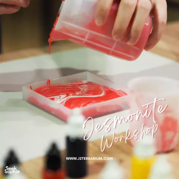 Hand pouring red resin into a hexagonal coaster mould on a workbench at marble & terrazzo coaster making workshops in Singapore