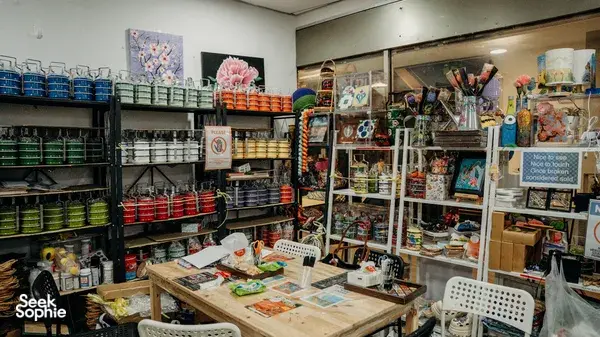 Colourful art supply shelves and painted samples in a Singapore Peranakan studio for mini kamcheng painting workshops in Singapore