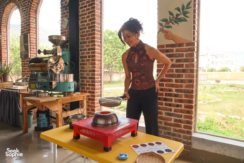 Seeker Yunnan Coffee Estate workshop in Lijiang: woman operates a coffee roaster, with sample tasting plates on a table