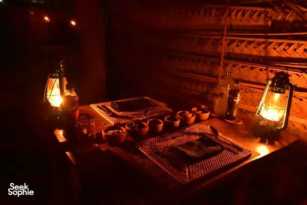 Candlelit table set-up in The Elephant Next Door restaurant in Udawalawe, with lantern lights and plated dishes