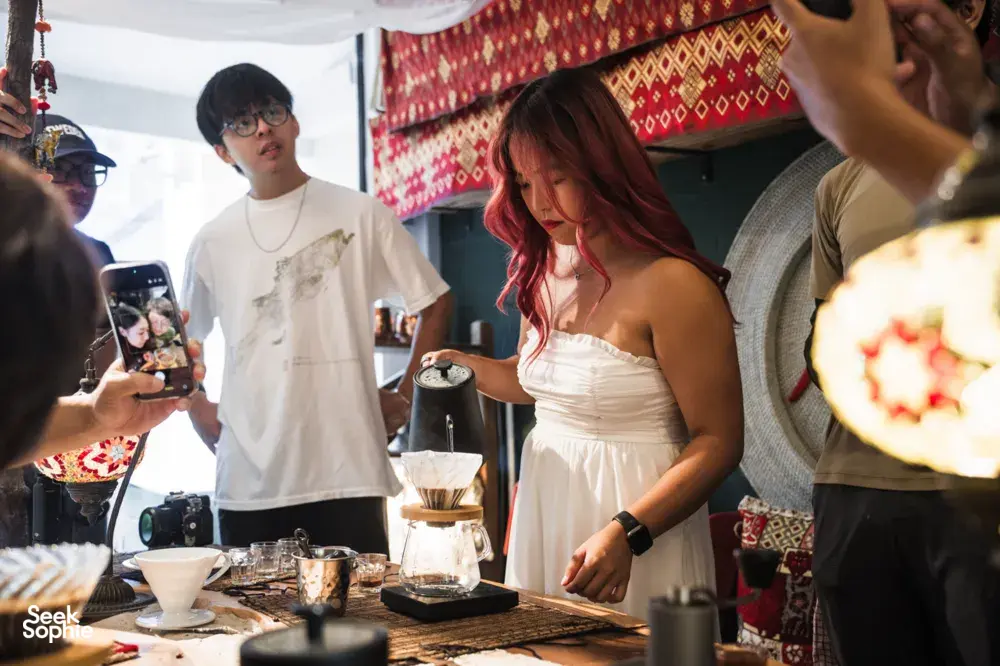Guests gathered around a coffee station at a Singapore hands-on brunch, sharing pours and tasting cups together — workshops in Singapore