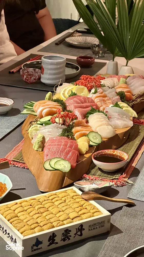 Assorted sliced seafood, cured meats and vegetables arranged on a wooden grazing platter at Primateve's table, private dining Singapore