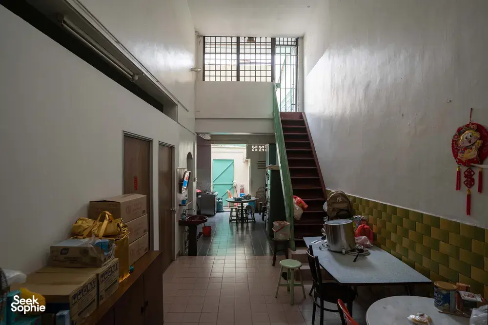 Jalan Besar backroom corridor with tiled floor, stairs, and stored clutter in Singapore, revealing Singapore hidden gems