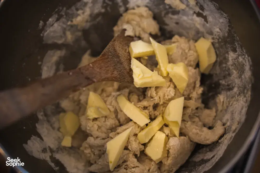 Butter cubes melting into a dough mixture in a cooking pot, showing part of a croissant bake in Singapore — workshops in Singapore