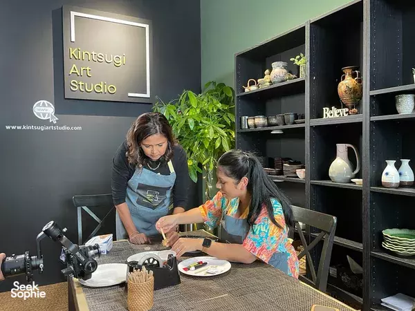Participants working at a kintsugi bench with tools and pieces at Kintsugi Art Studio, mending with gold during workshops in Singapore