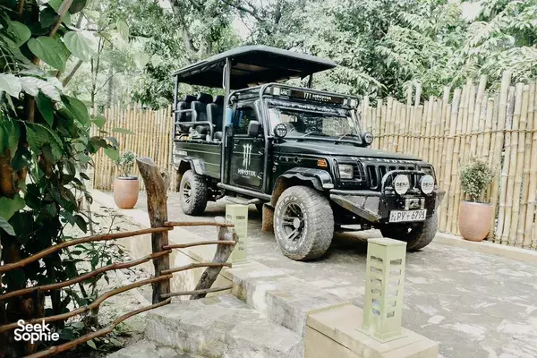 Safari jeep parked by the garden path at The Elephant Next Door in Udawalawe, ready for Udawalawe National Park safaris
