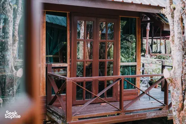 Wooden lodge deck with glass rail-lined veranda at Borneo Natural Sukau Bilit Resort for the Kinabatangan River