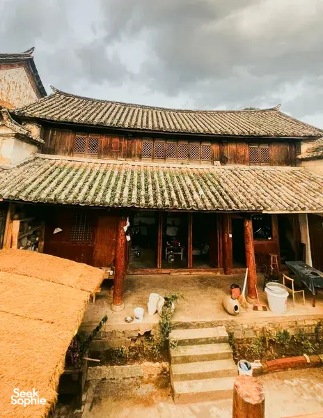 Courtyard of an ancient pottery village in Dali with traditional tiled roofs and a workshop frontage on a Discovery More day trip