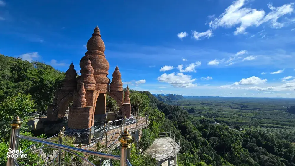 Buddhist stupa lookout over sweeping valley and green forest from Khao Sok National Park, with terrace railings