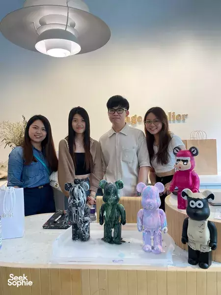 Sage Artelier guests sit by a table of painted Bearbrick figures during a private session workshops in Singapore