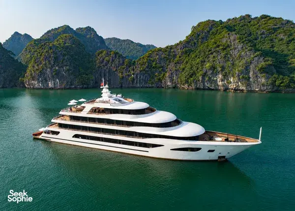 White Oasis Bay Party Cruiser sailing through Halong Bay with limestone karsts rising from turquoise water