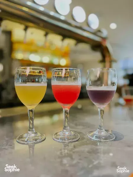 Three craft beer glasses on the bar counter at Lion Brewery Co in Singapore, served during a brewpub tour tasting