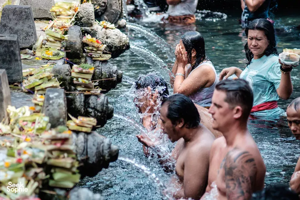 Locals & travellers experiencing Melukat, a traditional Balinese cleansing ritual