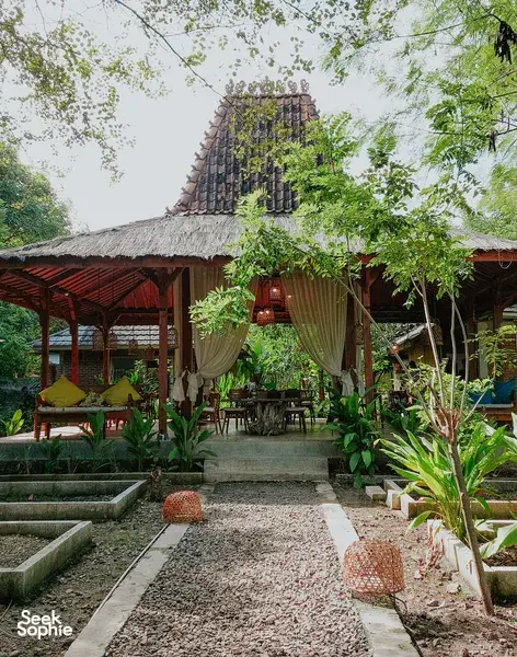 Garden courtyard seating with draped curtains at The Kitchen Garden Bajo for Traditional Manggarai vegan cooking, Labuan Bajo
