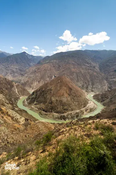 Winding turquoise river curving through rugged valleys in Meili country during a 2D2N sunrise adventure from Shangri-La