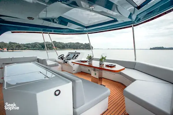 MS Eternity premium catamaran lounge with padded seating and sun-viewing daybeds over Singapore’s bay on the way to Lazarus Island