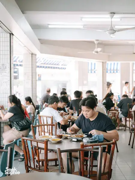Diners seated at a bright restaurant table during the Joo Chiat food tour together, Singapore hidden gems