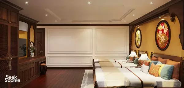 Cycad Cruise cabin with twin beds, warm wall art and tall mirrors, cosy lighting and curtains for Bai Tu Long Bay cruise