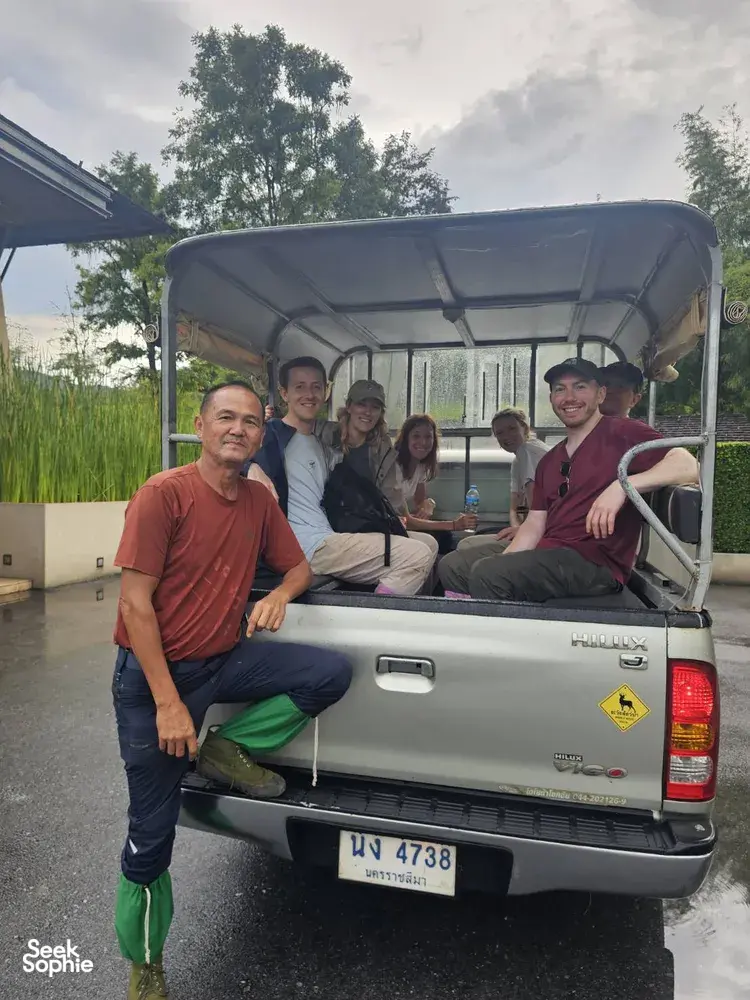 Travellers riding in the back of a pickup truck on a guided wildlife trek in Khao Yai National Park, Thailand
