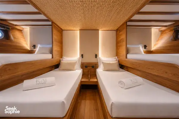 Travass Life phinisi cabin with twin beds, folded towels and neatly made linens, set for a rare 3D2N shared trip on Komodo Island