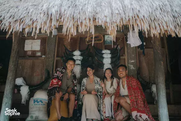 People sitting inside a traditional thatched hut in Sumba during a customised culture stop on a private car tour