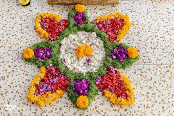 Colourful flower mandala arranged in a circle on a speckled studio floor for a sound healing ritual in Canggu