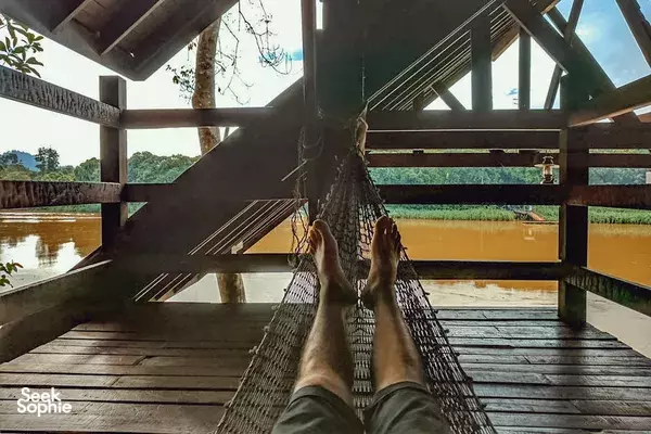 On a canoe hammock walkway drifting through jungle waterways near Sandakan on the Kinabatangan River