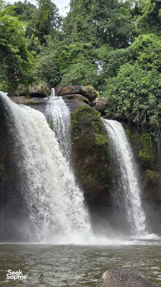 Waterfalls cascading into a misty pool through lush forest in Khao Yai National Park, Wildlife Safari Thailand
