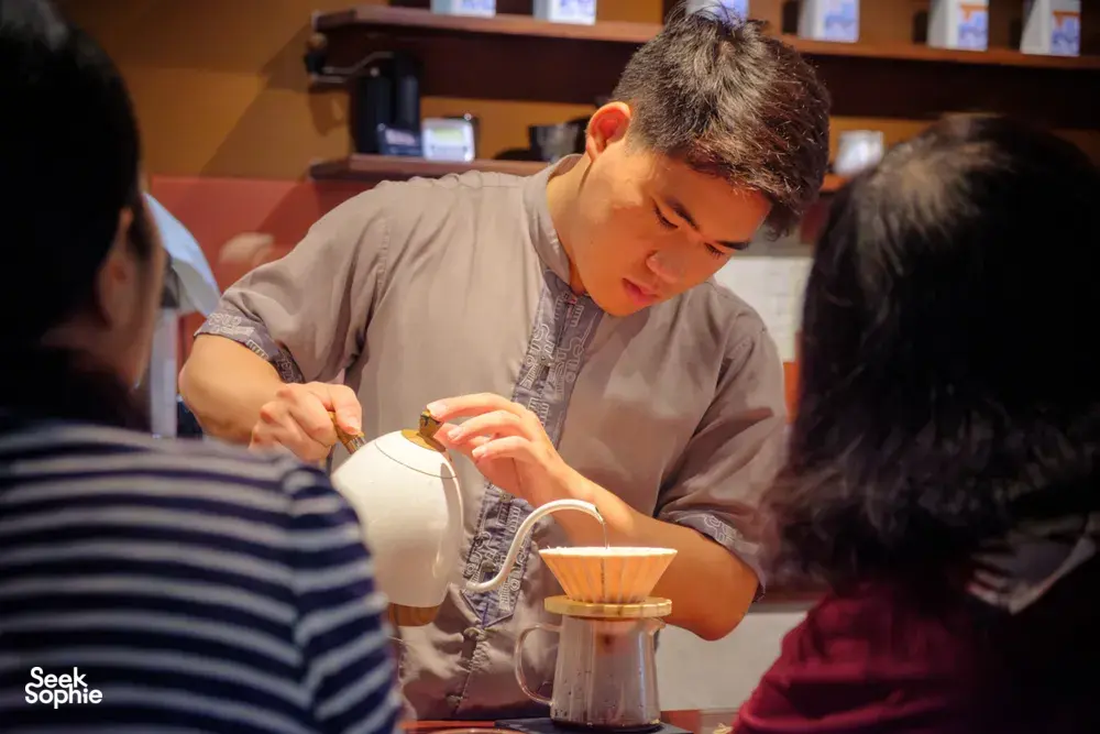 Tea poured during the Rare Agarwood Tour in Hanoi, with tasting cups and a traditional teapot at the host-led session by Up Travel Vietnam