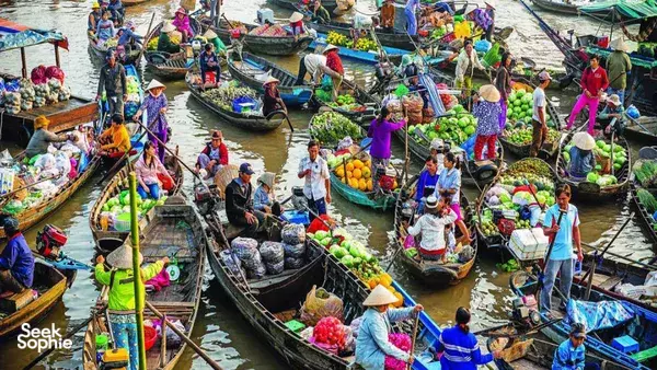 Crowded floating market of many boats selling fruit and vegetables along a river, a classic Ho Chi Minh City waterway transport scene