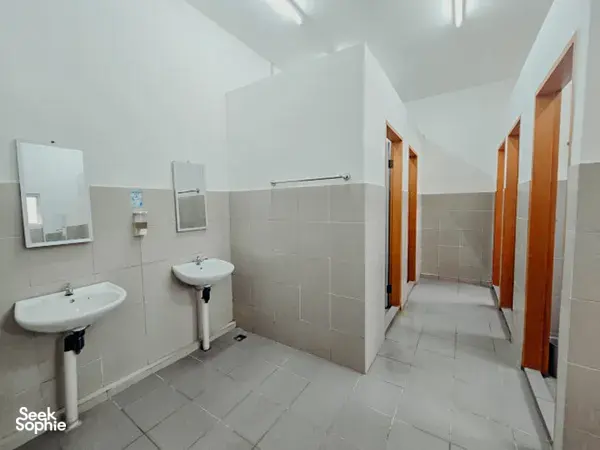 KOPEL Kinabatangan bathroom in Sandakan with two basins, wall mirrors and tiled floors for your safari on the Kinabatangan River